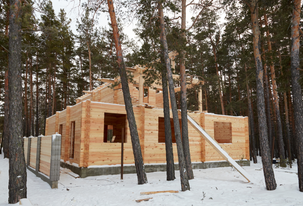 New home under construction surrounded by pine trees